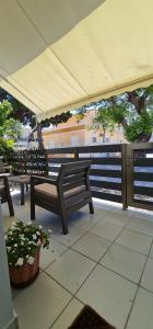 two benches sitting under a tent on a patio at Sea & Sun cozy studio in Kremasti