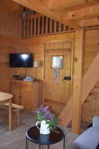 a log cabin with a door and a table with flowers at Chalet L'Armoy in La Giettaz