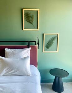 a bedroom with a white bed and a table at Campanile Saint Brieuc - Centre Gare in Saint-Brieuc +58 photos