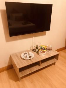 a wooden coffee table with a television on a wall at 27A on Angus in Johannesburg