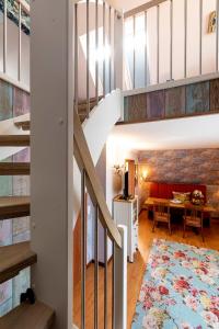 a staircase in a home with a living room and a dining room at Landhaus Wremer Deel in Wremen