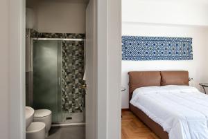a bedroom with a bed and a shower at ARMONIE Salesiani Lecce in Lecce
