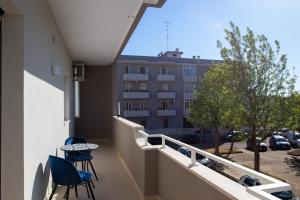a balcony with two chairs and a table and a building at ARMONIE Salesiani Lecce in Lecce +10 photos