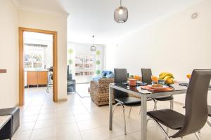 a dining room and living room with a table and chairs at #055 São José V by Home Holidays in Branqueira