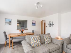 a living room with a couch and a table at 31 Beach Road in Porthmadog