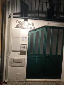 Una puerta verde en una habitación con máquina en Casa da Rocha - Alojamento Local en Vila Nova de Foz Cõa