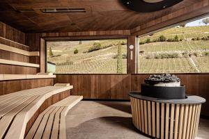 a room with a large window and a cake on a table at Lake Spa Hotel SEELEITEN in Caldaro +28 photos