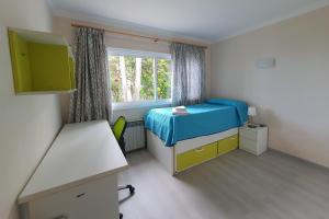 a small bedroom with a bed and a window at Balcón del Teide in La Orotava +69 photos
