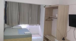 a small room with a bed and a television at Piaui Apart Hotel in Teresina