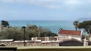 a house with a stone wall and a bridge at Extra lokacija!!!!! in Sutomore