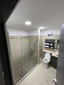 a bathroom with a shower and a toilet at Hotel Wanderlust in Santa Marta
