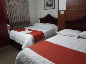 Postel nebo postele na pokoji v ubytování Hotel Tungurahua