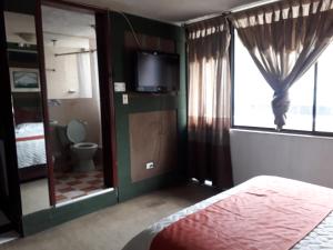 Postel nebo postele na pokoji v ubytování Hotel Tungurahua