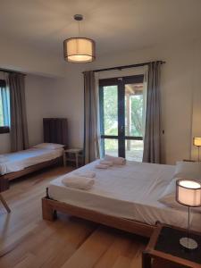 a bedroom with a large bed and a large window at ALTANA in Torraca