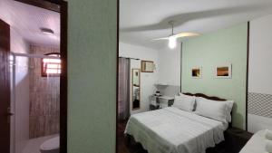 Ένα ή περισσότερα κρεβάτια σε δωμάτιο στο Lar de Nanci e Beto