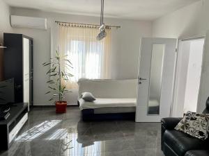 a living room with a bed and a couch at Apartment Oblak in Vrsi