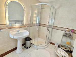a bathroom with a sink and a shower at 'Senán' Luxury Double Room in Foxford
