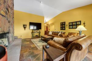 a living room with leather couches and a fireplace at Four Queens in Chapel in Sedona