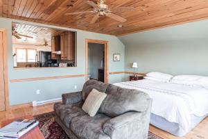 a bedroom with a bed and a couch at The Loft at the Barn in Bolivar