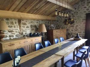 a dining room with a large wooden table and chairs at Maison charmante à Lanarce avec vue sur la montagne, jacuzzi. in Lanarce