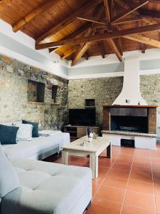 a living room with a couch and a fireplace at Citrus garden in Ancient Epidauros