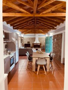 a kitchen with a wooden table and chairs at Citrus garden in Ancient Epidauros