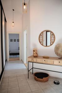 a hallway with a table and a mirror on the wall at Cozy modern apartment in the Old Town - Hlavna street in Košice +17 photos