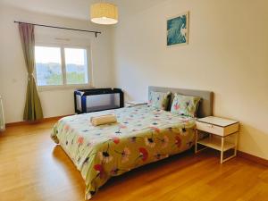 a bedroom with a bed and a television in it at Sunny Home Lisboa Expo, free parking in Lisbon