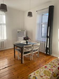 a dining room with a table and two chairs at Spacious Ausekla apartment in Liepāja