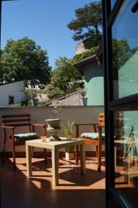a patio with a table and chairs on a patio at Olivea penzion & wine Mikulov in Mikulov