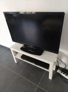 a flat screen tv on a white tv stand at O'Couvent - Appartement 524 - 5 chambres - 125 m2 - Deuxième étage in Salins-les-Bains
