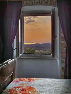 a window with a view of a mountain view at Kaya house in Nerežišće