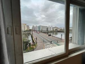 a window with a view of a city street at Rede Andrade Plaza Recife in Recife