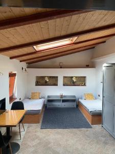 a room with two beds and a table and a table sidx sidx sidx at Apartmany Vila Lucia 6 in Pilsen