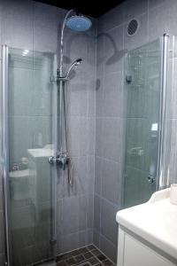 a bathroom with a shower with a glass door at Roosi apartment Haapsalu in Haapsalu