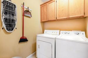 a laundry room with a washing machine and a broom at Wine Country Hideaway in Windsor