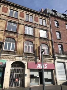 a large brick building with an ahs sign on it at Capsule Wellness - sauna - balneo - machine de sport privatif - PS5 - 2 chambres in Valenciennes