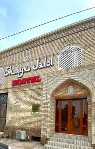 a brick building with a sign that reads shrek juliard at Shayx Jalol in Bukhara