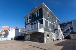 a black building with a balcony on the side of it at Seaside Sands Inn in Seaside Heights