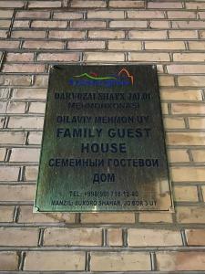 a plaque on the side of a brick wall at Shayx Jalol in Bukhara