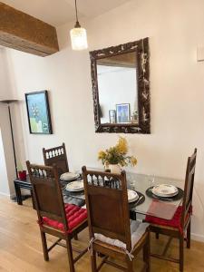 - une salle à manger avec une table, des chaises et un miroir dans l'établissement Beautiful appartment in the heart of Paris, à Paris