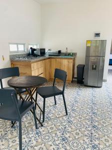 a kitchen with a table and chairs and a refrigerator at CASA JURADO in Medellín