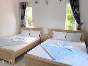 Кровать или кровати в номере Song Châu Villa Quan Lạn