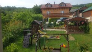 a backyard with a playground and a house at Apartmán Zlatá rybka in Podhájska