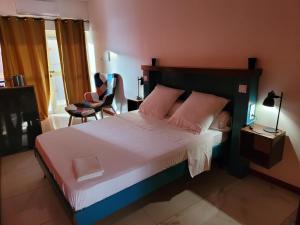 מיטה או מיטות בחדר ב-Yangou Appart 1