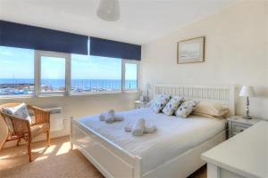 a bedroom with a bed with a view of the ocean at Halyards, La Casa in Lyme Regis