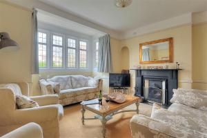 a living room with a couch and a fireplace at 2 Old Home Farm in Lyme Regis