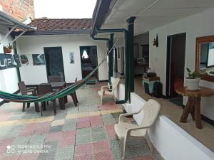 a living room with a hammock and a table and chairs at Hostal Donde Jose in Guadalupe