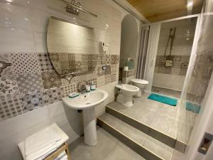 uma casa de banho com um lavatório, um WC e um chuveiro em Pompei Civico 84 em Scafati