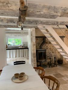 a dining room with a table and a fireplace at L Ostal in Trélissac
